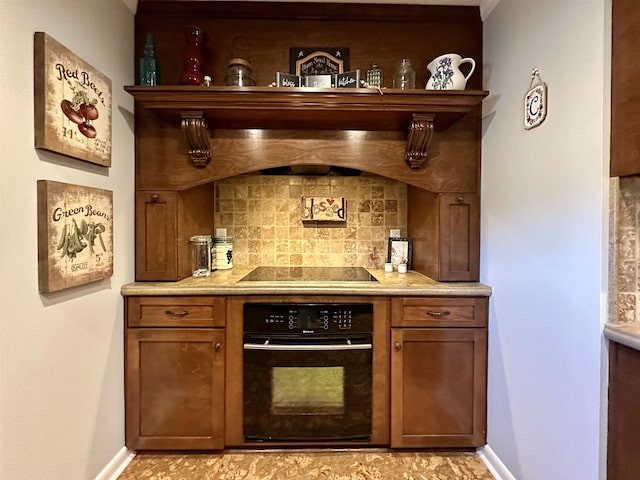 bar featuring tasteful backsplash and black appliances