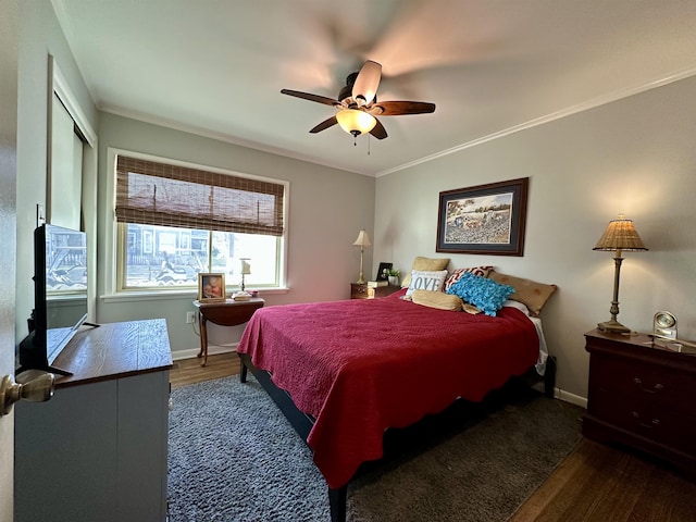 bedroom with ceiling fan, dark hardwood / wood-style floors, and crown molding