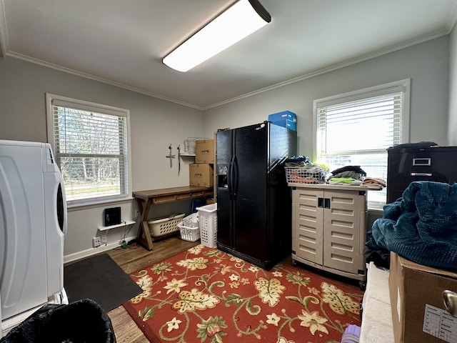 interior space with washer / dryer, crown molding, and hardwood / wood-style floors