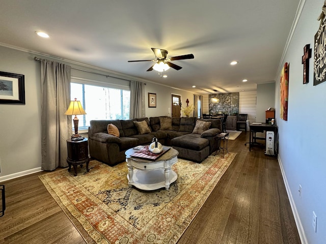 living room with ceiling fan, dark wood-type flooring, and ornamental molding