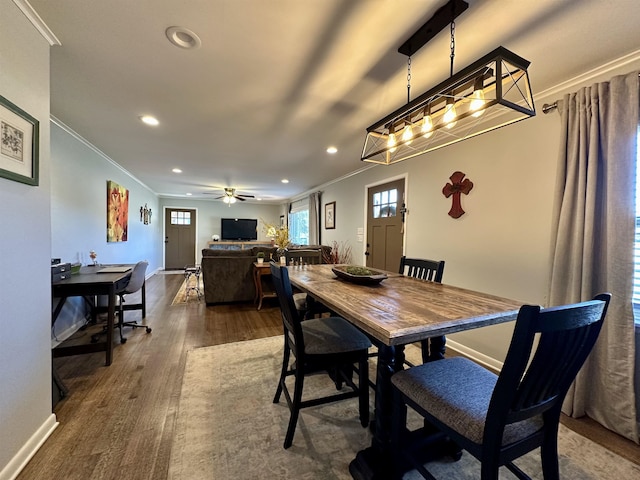 dining area with crown molding, ceiling fan, and dark wood-type flooring