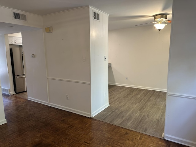 empty room with ceiling fan and dark parquet floors