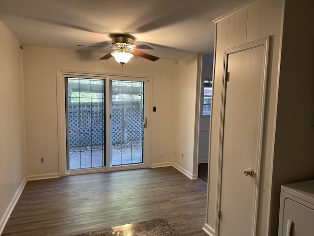 unfurnished room with ceiling fan, dark hardwood / wood-style flooring, and washer / dryer