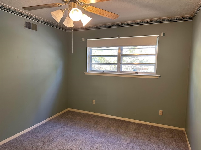 empty room featuring ceiling fan, crown molding, carpet floors, and a textured ceiling