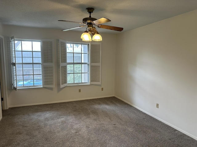 unfurnished room featuring ceiling fan and dark carpet