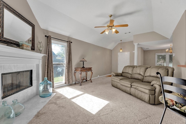 carpeted living room featuring a tile fireplace, ceiling fan, and lofted ceiling