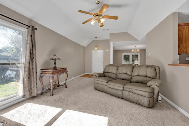 living room featuring ceiling fan with notable chandelier, light colored carpet, decorative columns, and lofted ceiling