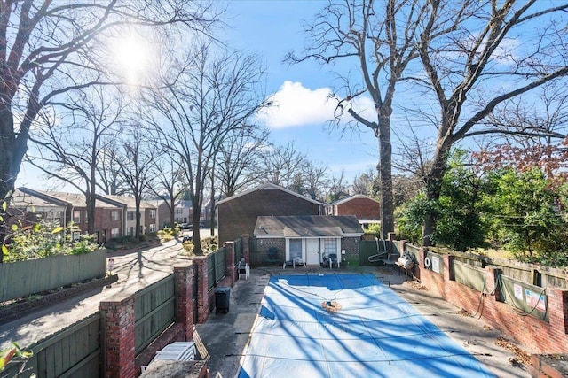 exterior space featuring a covered pool and an outdoor structure