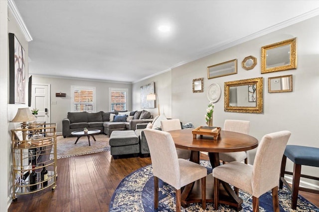 dining space featuring dark hardwood / wood-style floors and ornamental molding