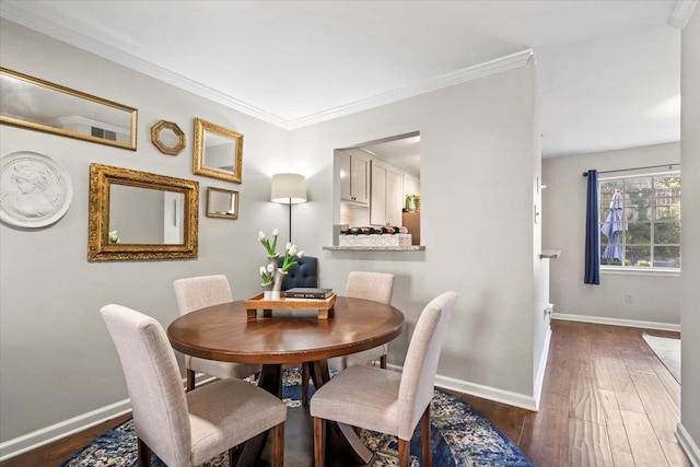 dining space with dark hardwood / wood-style floors and crown molding