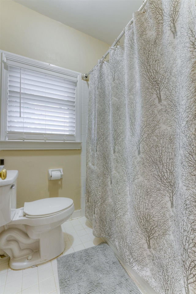 bathroom with tile patterned floors and toilet