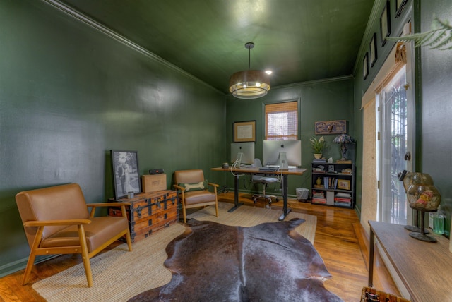 office area with light hardwood / wood-style floors and ornamental molding