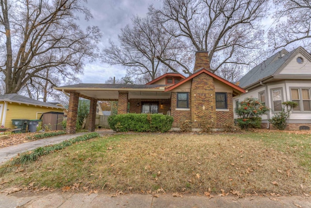 view of front of house with a front yard and a carport