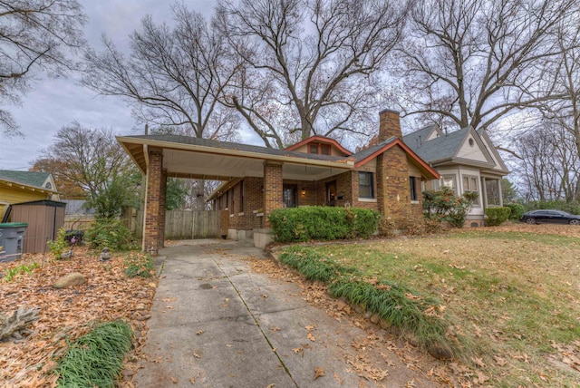 view of front of house with a front yard and a carport