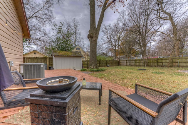 view of patio with central AC unit, a storage unit, and a deck