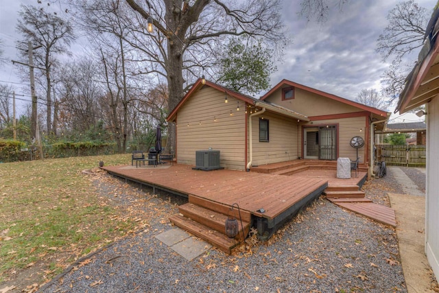 back of house with a wooden deck and central AC