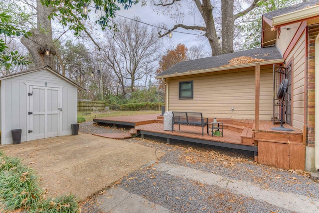 view of patio with a wooden deck and a shed