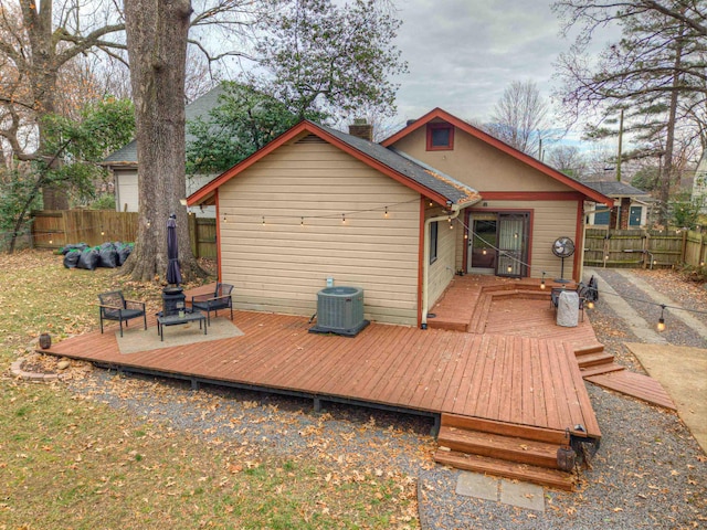 back of house featuring central air condition unit and a deck