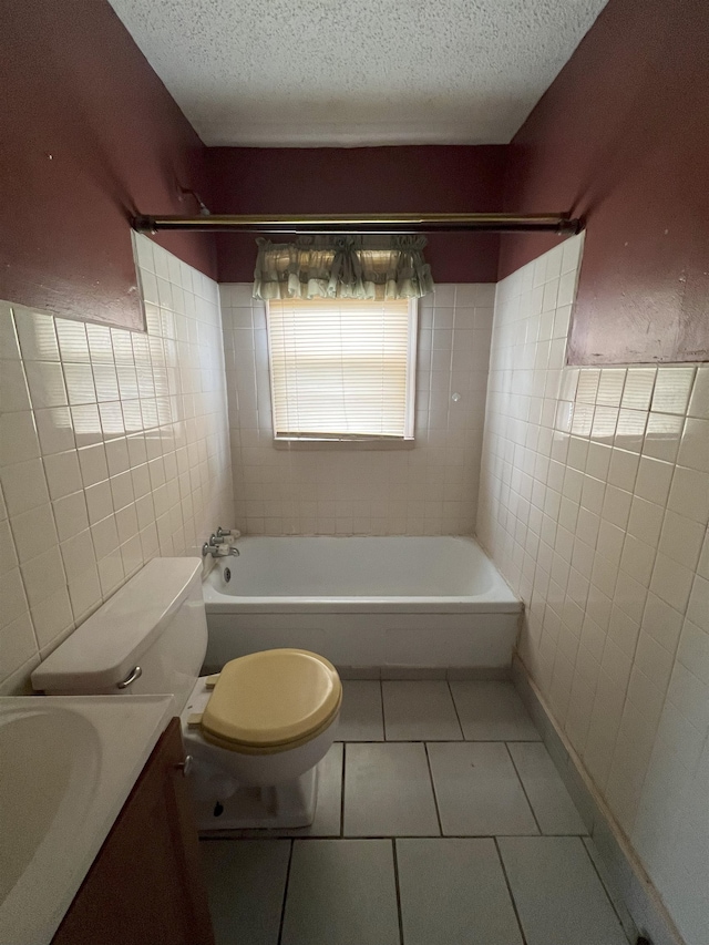 full bathroom featuring vanity, a textured ceiling, tile walls, tile patterned flooring, and toilet