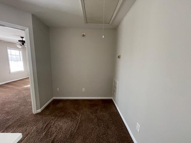 unfurnished room featuring dark carpet and ceiling fan