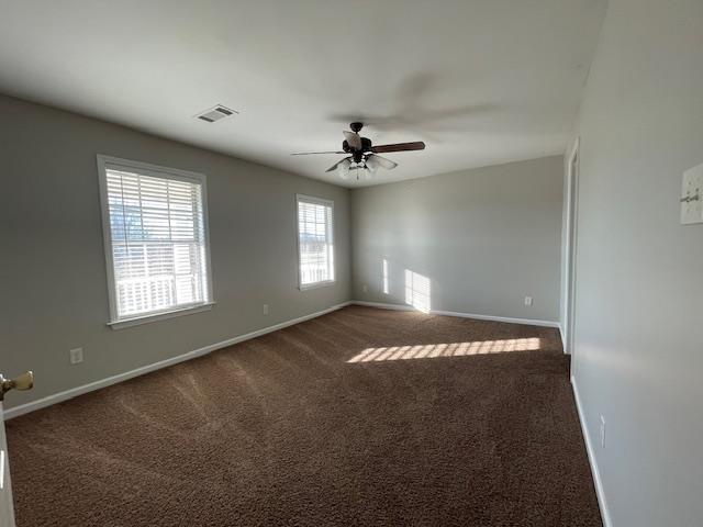 carpeted spare room with ceiling fan