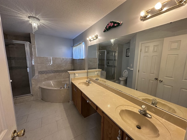 full bathroom with vanity, tile patterned flooring, toilet, a textured ceiling, and independent shower and bath