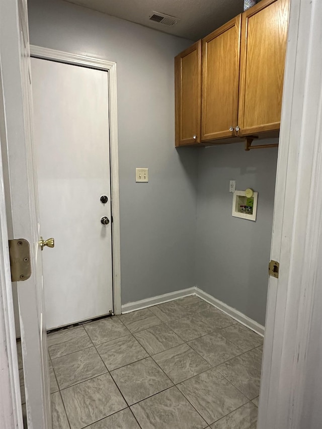 laundry area featuring washer hookup and cabinets