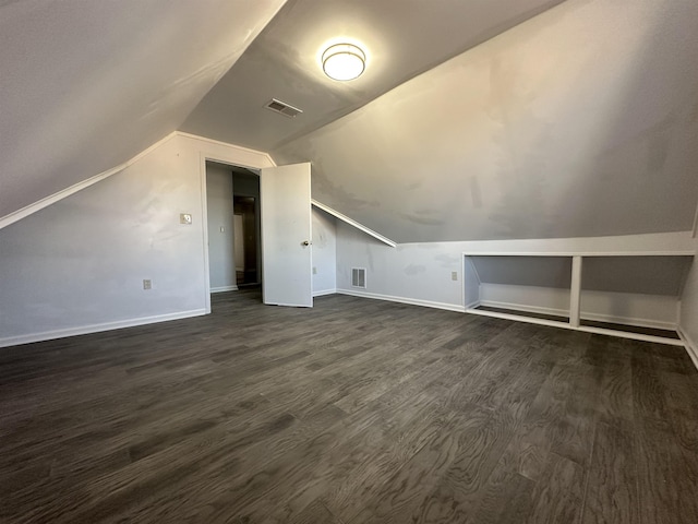 bonus room with dark hardwood / wood-style floors and lofted ceiling