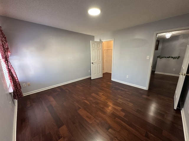 unfurnished bedroom with dark wood-type flooring