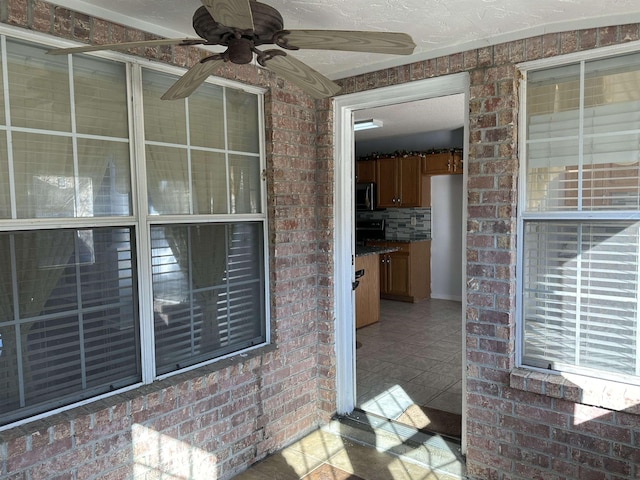 view of exterior entry featuring ceiling fan