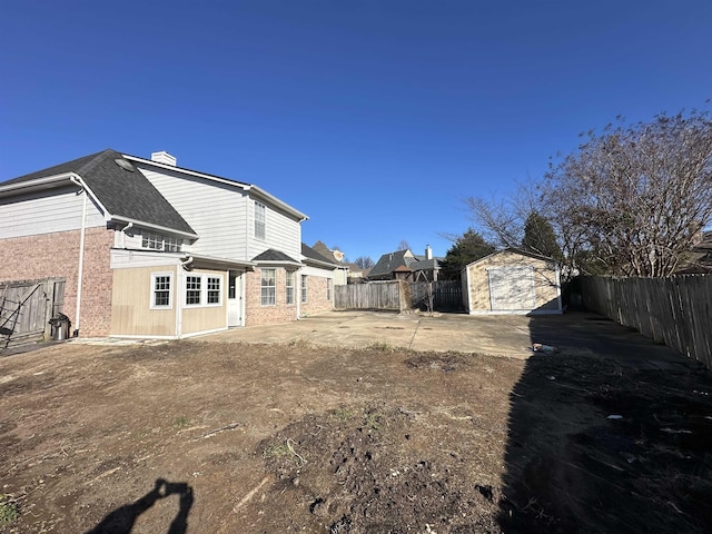 back of property featuring an outbuilding and a garage