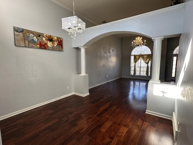 unfurnished dining area featuring ornamental molding, dark wood-type flooring, and a notable chandelier