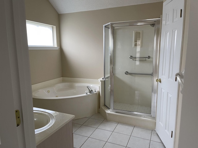 bathroom featuring tile patterned floors, sink, vaulted ceiling, shower with separate bathtub, and a textured ceiling