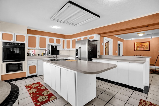 kitchen with white cabinets, black appliances, light tile patterned floors, a kitchen island, and kitchen peninsula