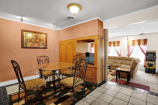 tiled dining area with crown molding and a textured ceiling