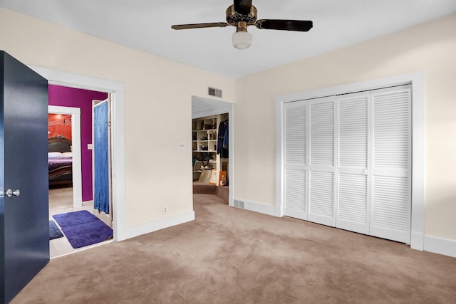 unfurnished bedroom featuring light carpet, a closet, and ceiling fan