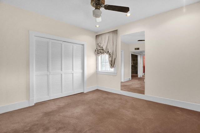 unfurnished bedroom with carpet flooring, a closet, and ceiling fan