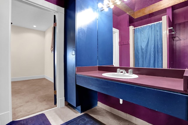 bathroom with tile patterned floors, sink, and a shower with shower curtain