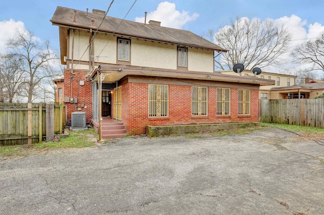 back of house featuring central air condition unit