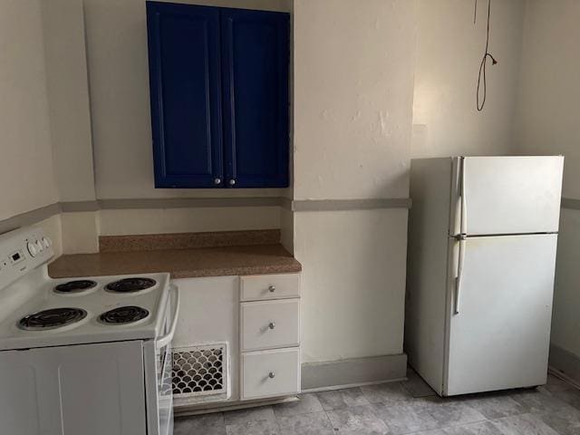 kitchen with white appliances and blue cabinets