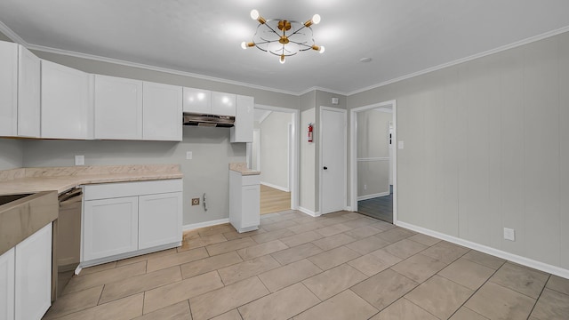 kitchen with white cabinetry, dishwasher, an inviting chandelier, light tile patterned floors, and ornamental molding