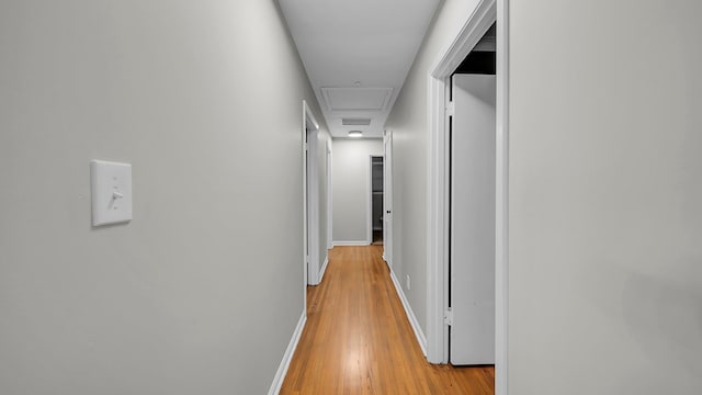 hallway with light hardwood / wood-style floors