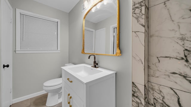 bathroom featuring tile patterned flooring, vanity, and toilet