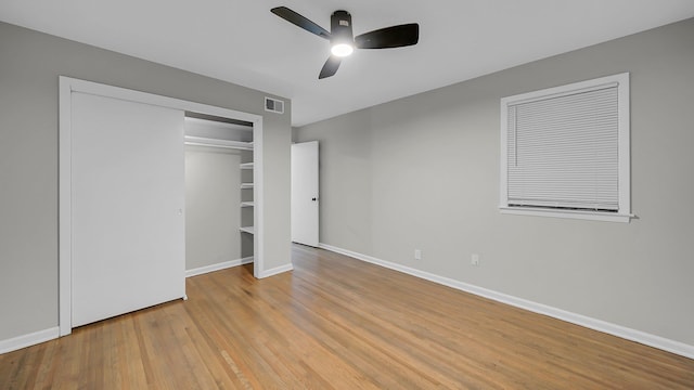 unfurnished bedroom featuring ceiling fan, a closet, and light hardwood / wood-style flooring