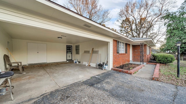 view of exterior entry with a carport