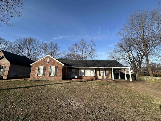 view of front of property with a front lawn and a carport