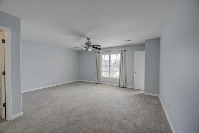 carpeted empty room featuring ceiling fan