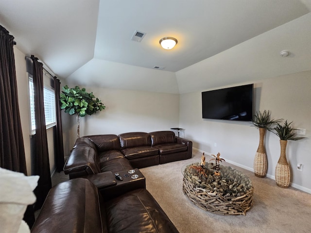 carpeted living room with lofted ceiling