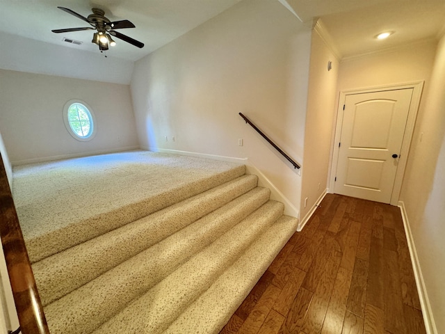 stairway with ceiling fan, crown molding, vaulted ceiling, and hardwood / wood-style flooring