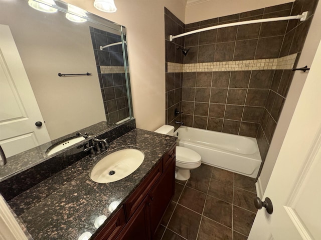 full bathroom featuring tile patterned flooring, toilet, vanity, and tiled shower / bath